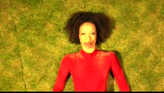 Close-up video of Gesel Mason lying on the grass for Rain